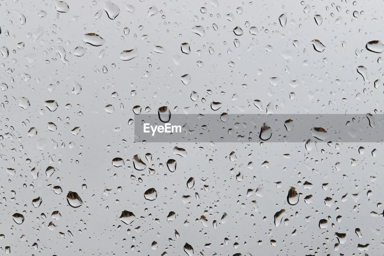 Water droplets condensed on transparent window. water rain drops.