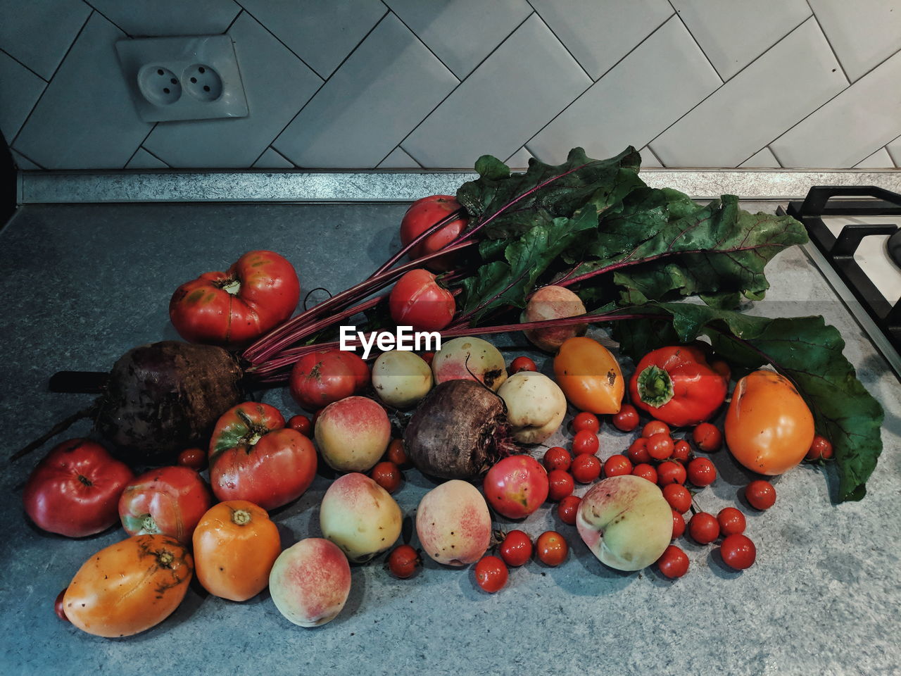 HIGH ANGLE VIEW OF APPLES AND VEGETABLES ON FLOOR