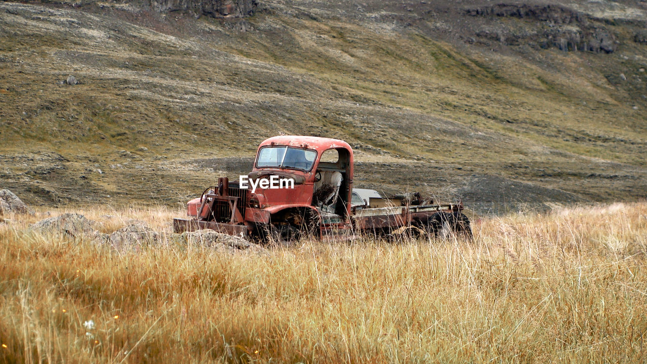 Abandoned truck standing on field