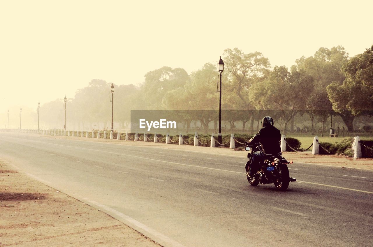 PERSON RIDING BICYCLE ON ROAD