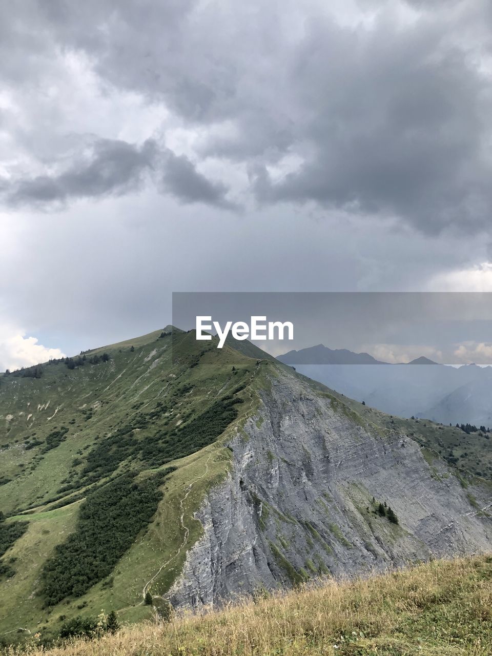 cloud, sky, nature, beauty in nature, scenics - nature, no people, environment, outdoors, cliff, day, mountain, mountain range, low angle view, rock, land, terrain, landscape, travel, sunlight, travel destinations, water, architecture