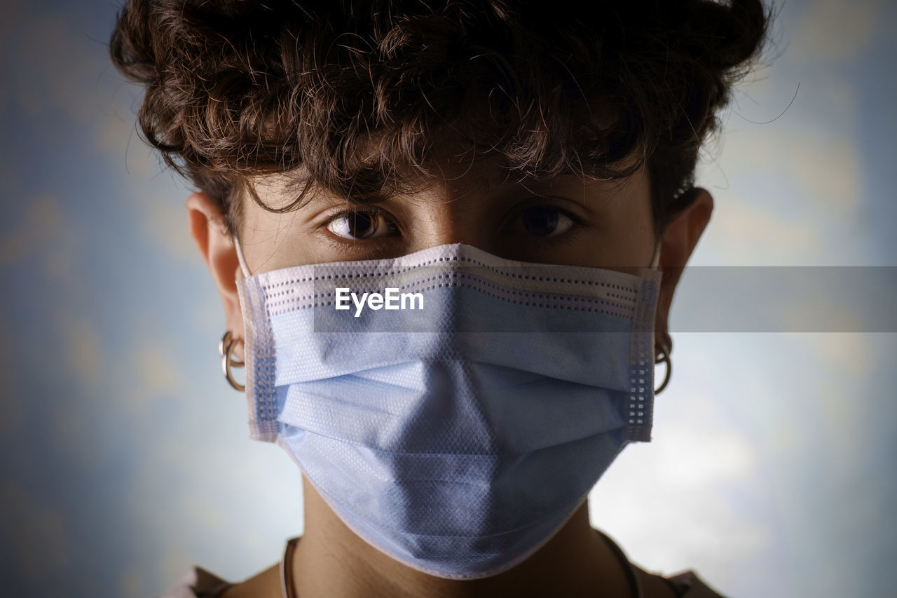 Portrait of young woman with protective mask during coronavirus pandemic 