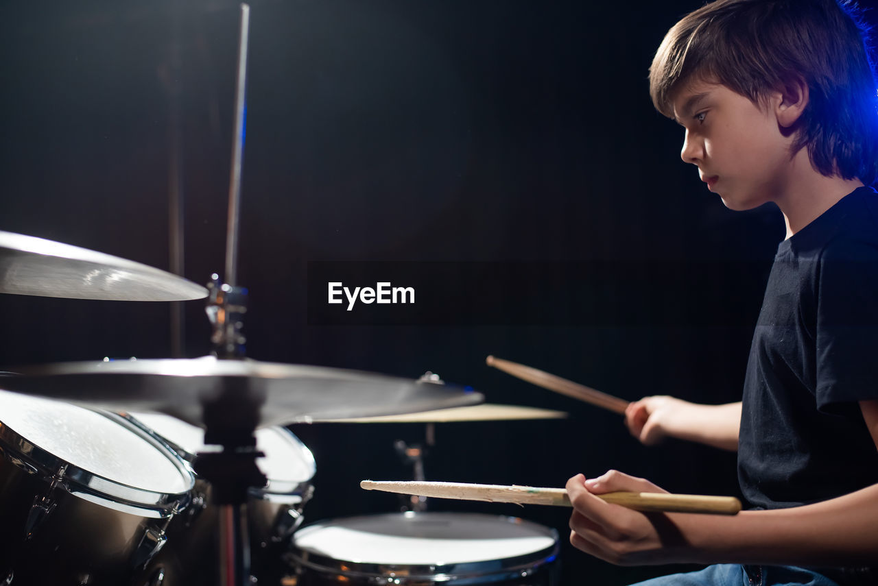 man playing drum at home