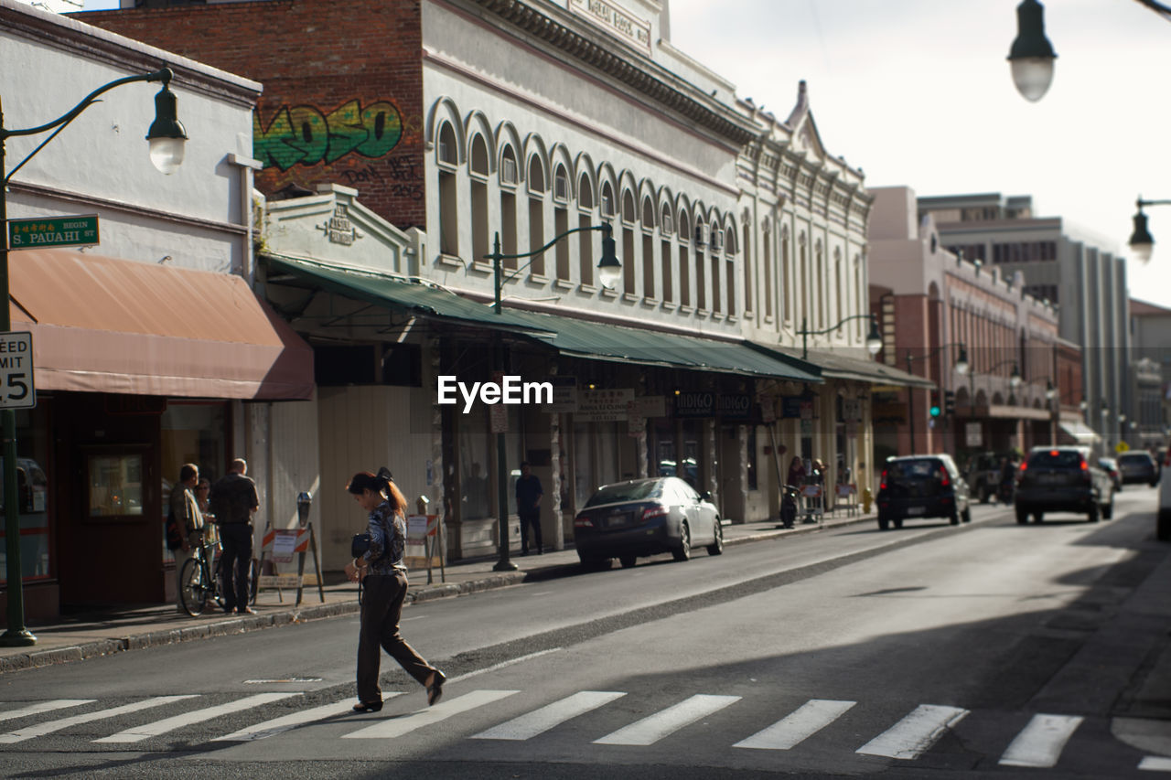 PEOPLE WALKING ON CITY STREET