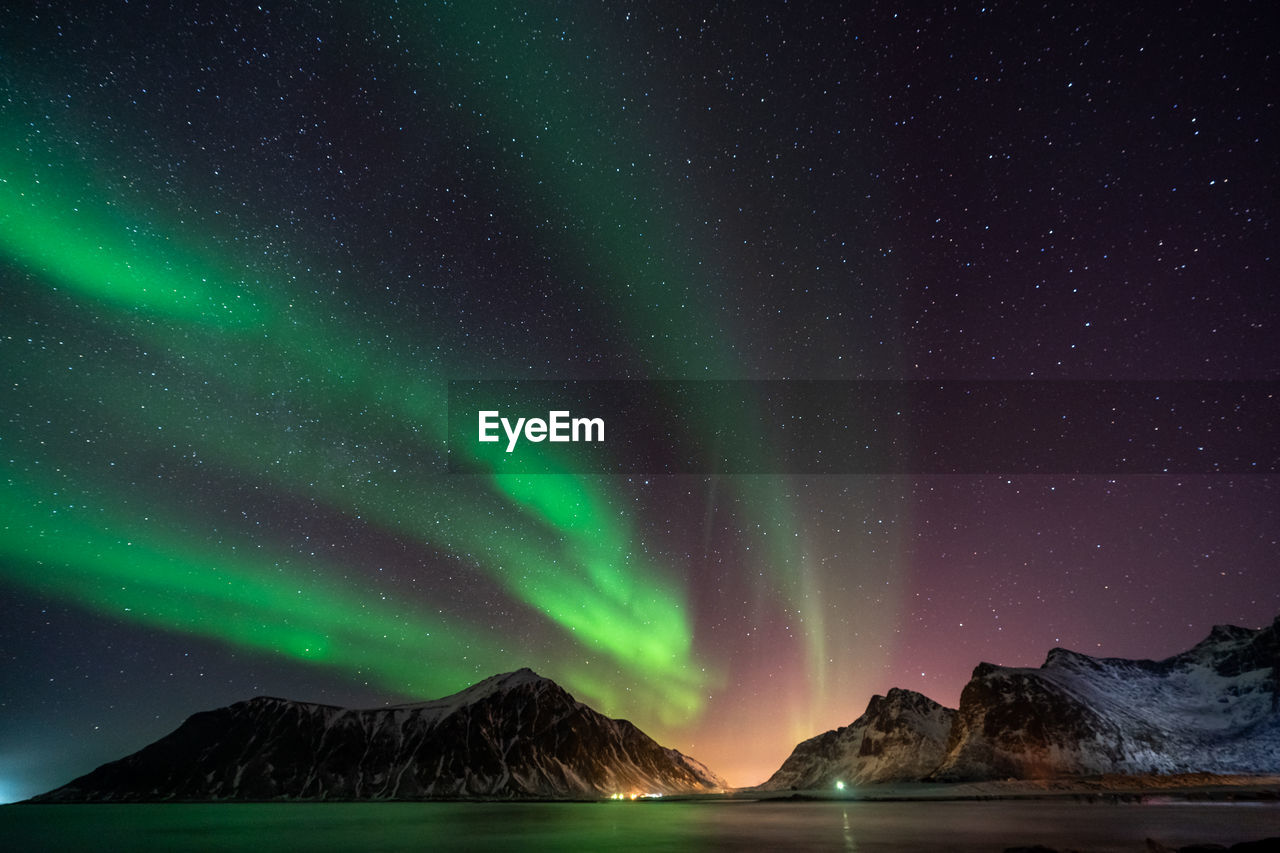 Scenic view of snowcapped mountains against sky at night