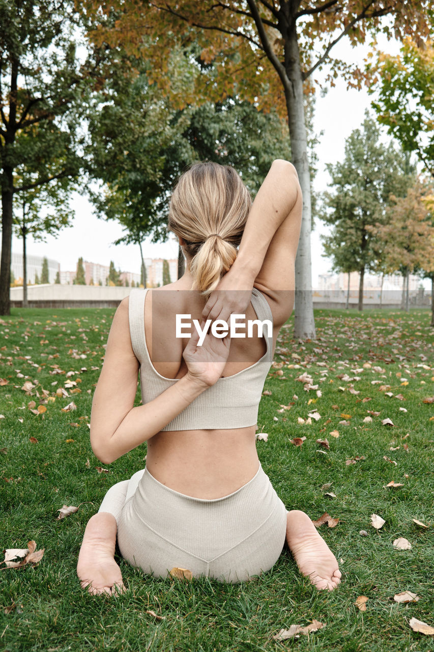 side view of young woman exercising in park