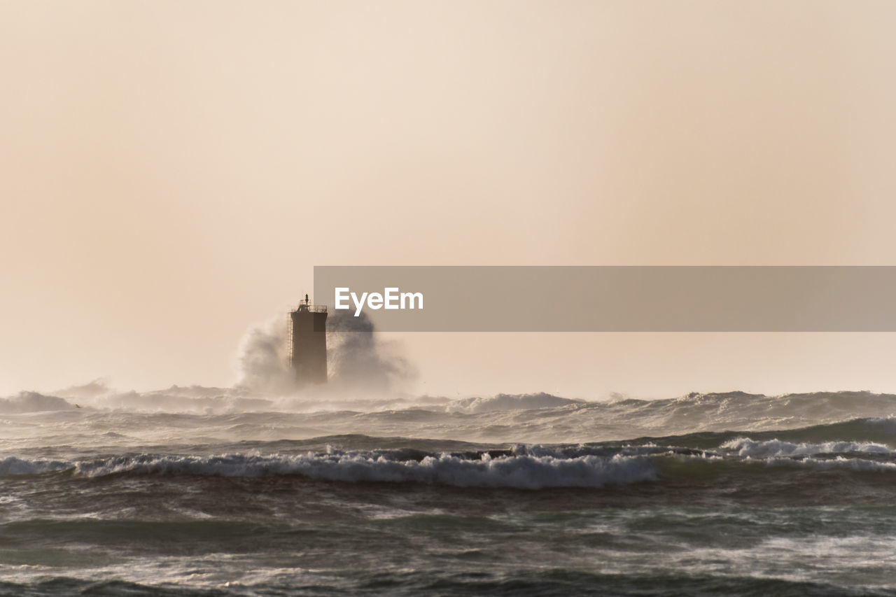 Huge wave storming the lighthouse