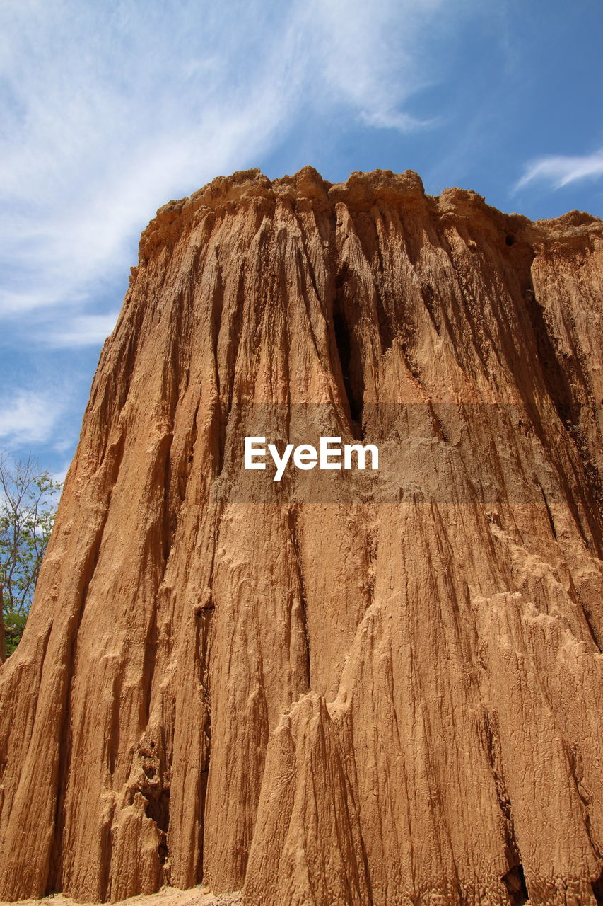 Low angle view of rock formation against sky