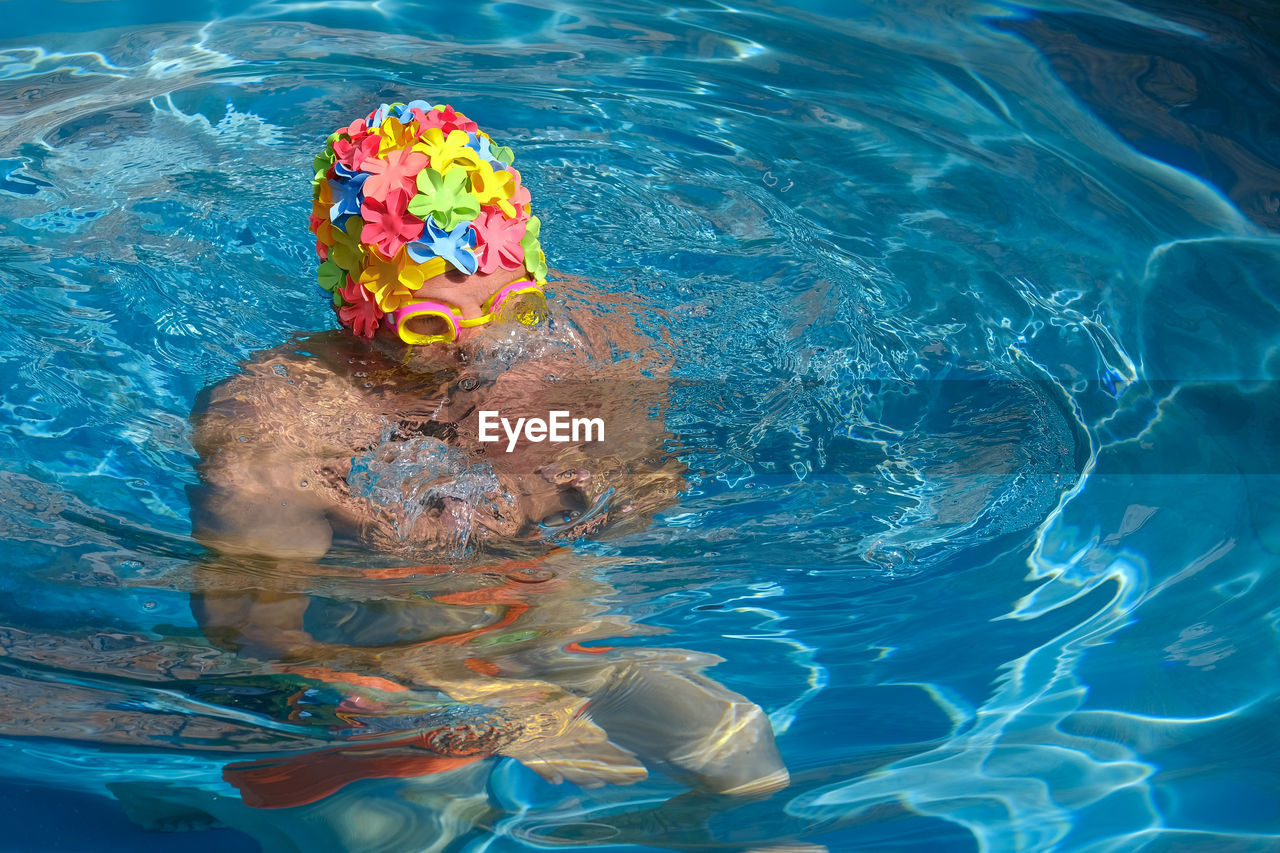 High angle view of man wearing swimming cap in pool