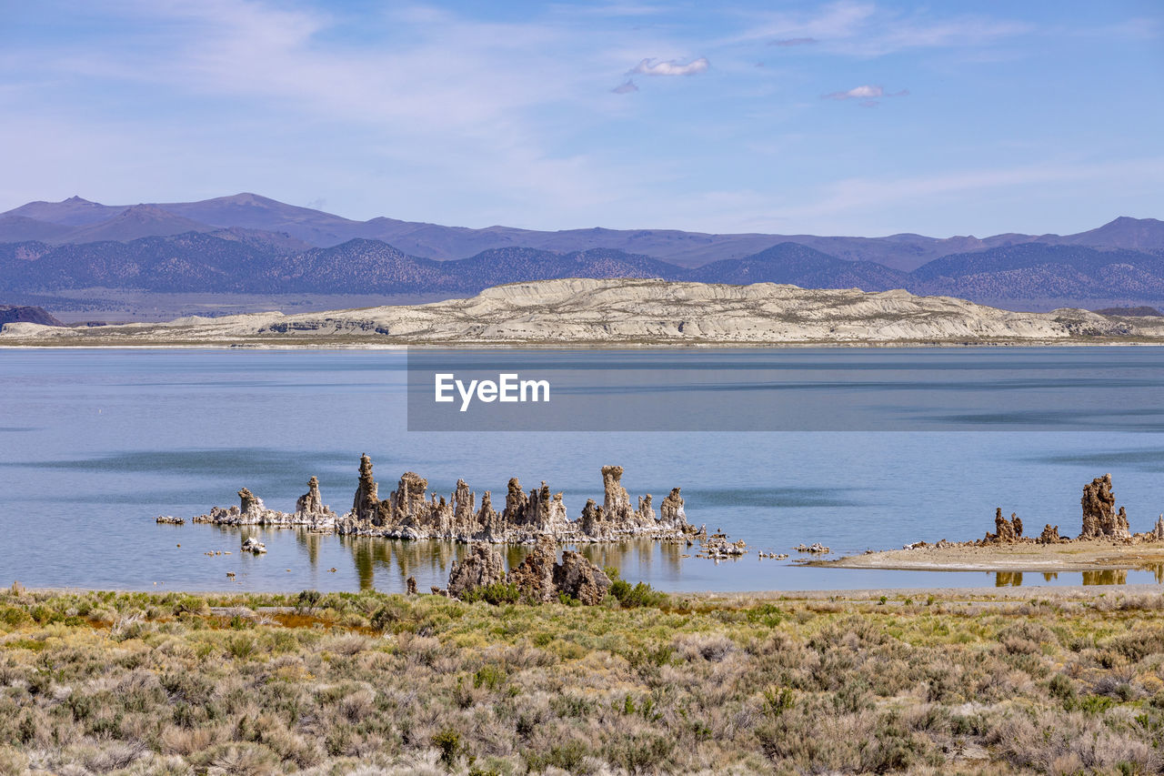 scenic view of sea and mountains against sky