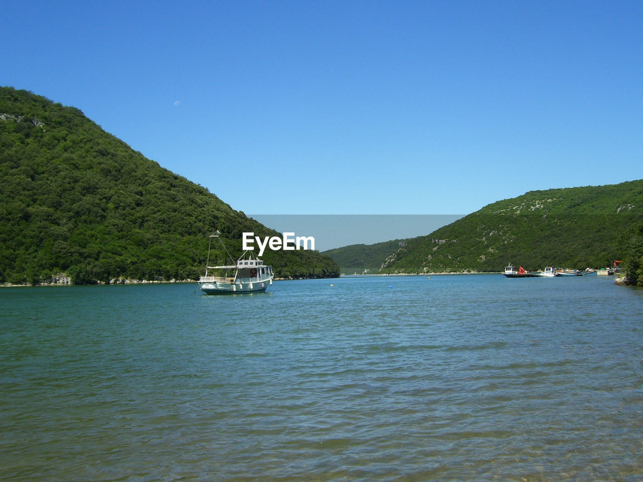 Scenic view of sea against clear blue sky