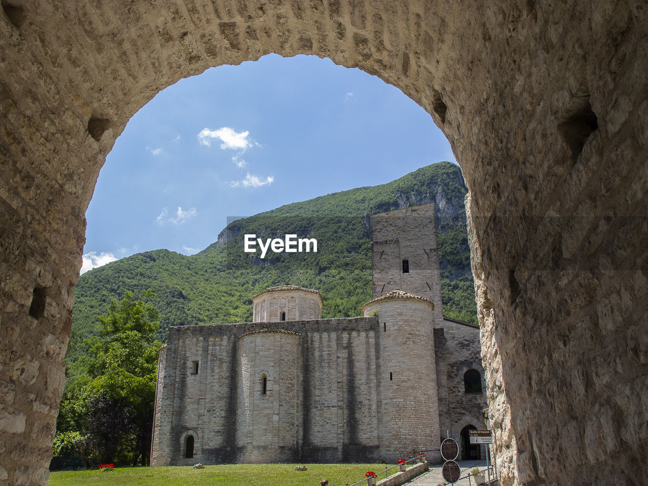 VIEW OF OLD RUIN BUILDING THROUGH WINDOW