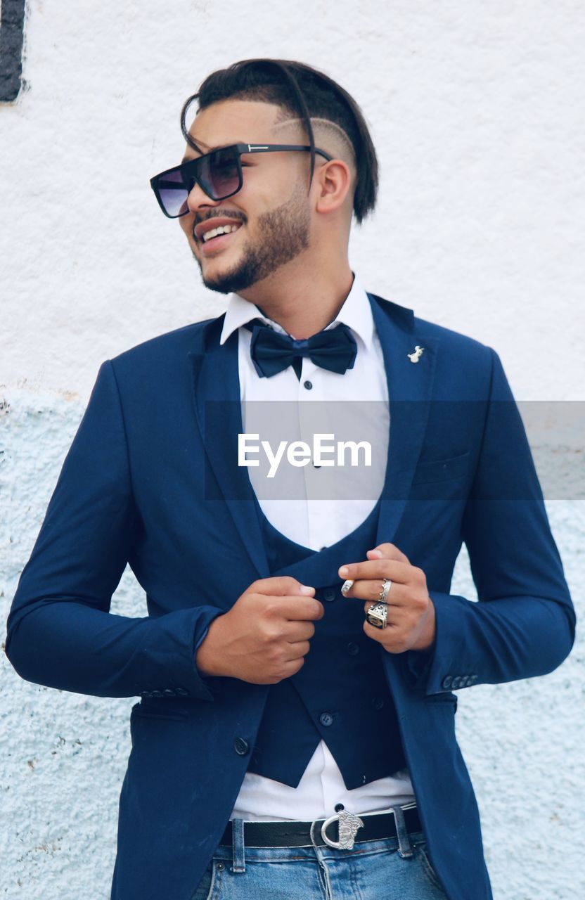 Young man wearing sunglasses standing outdoors