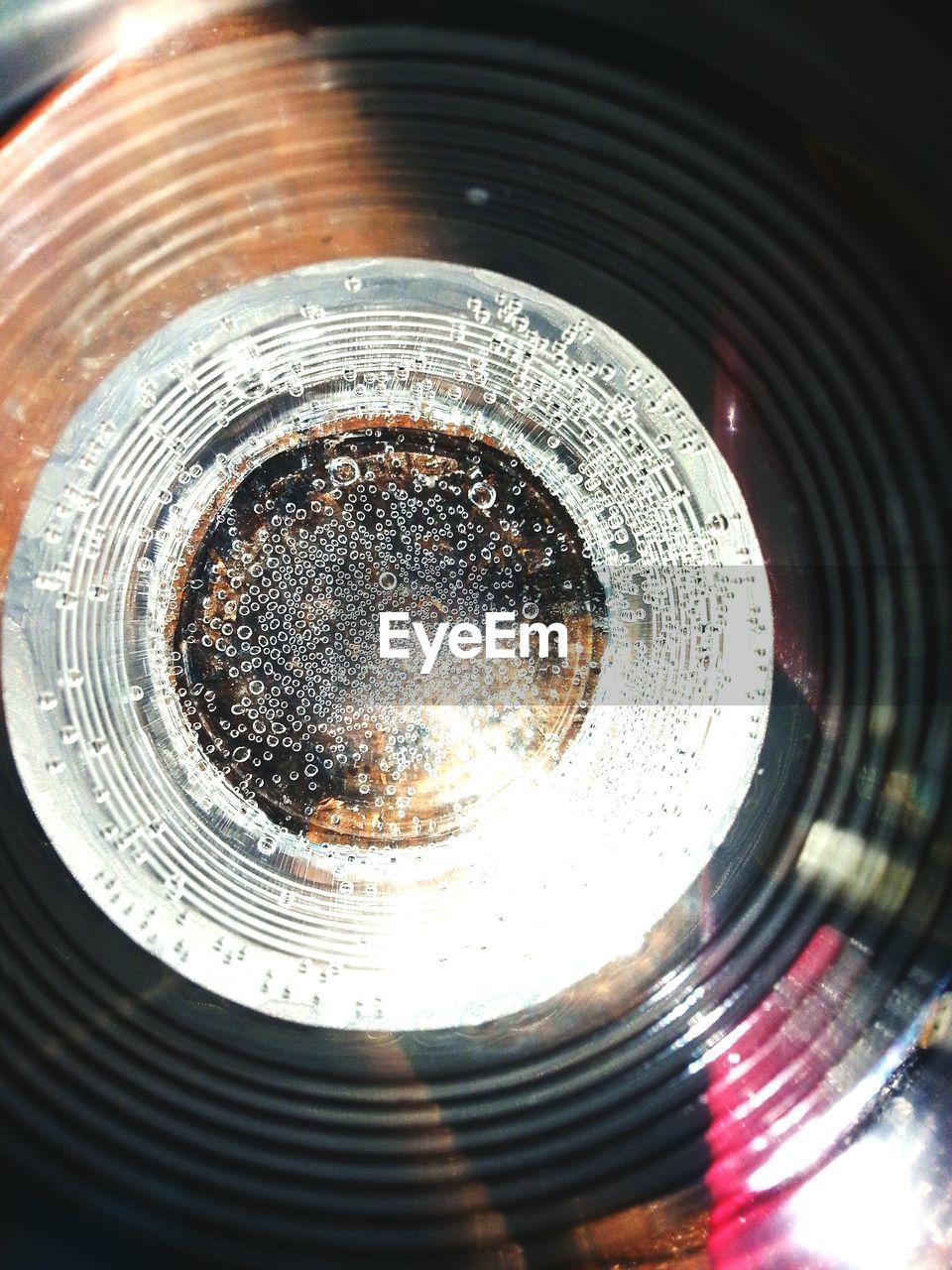 Directly above view of bubbling water in drinking glass