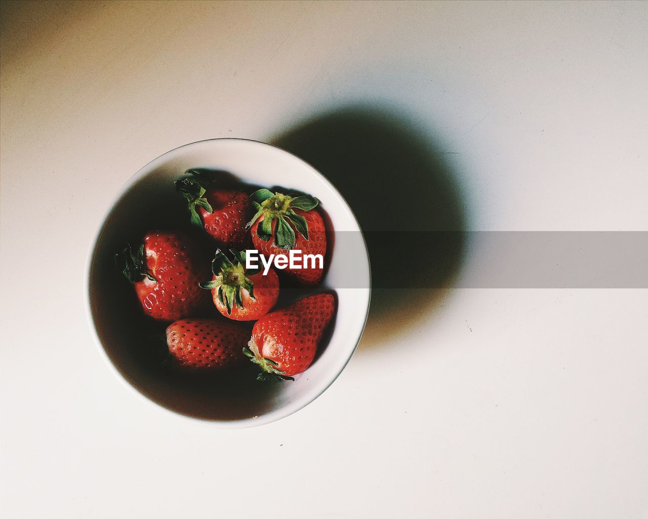 High angle view of strawberries in bowl on table