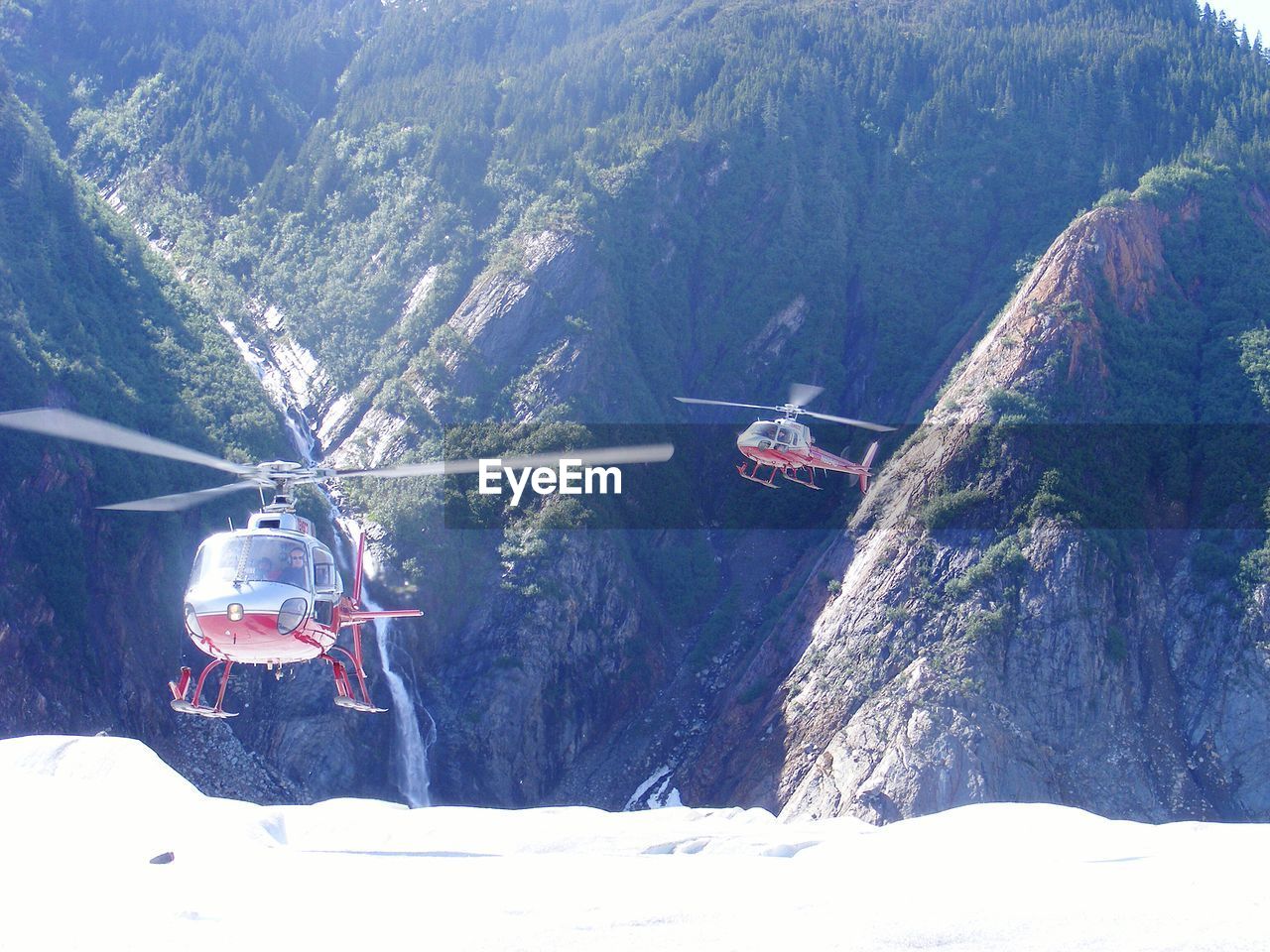 Helicopters flying above mountains