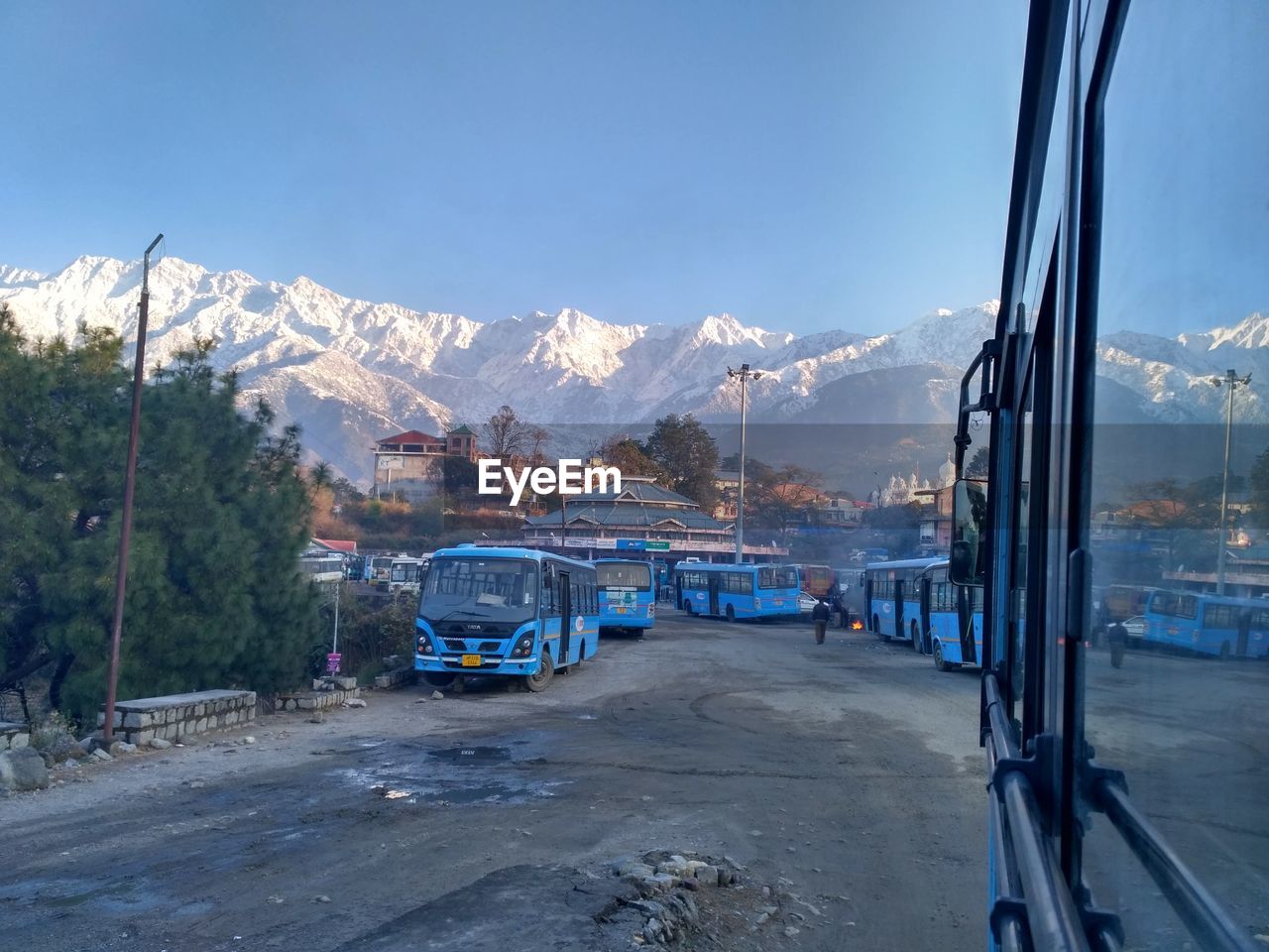 Cars on snowcapped mountains against sky