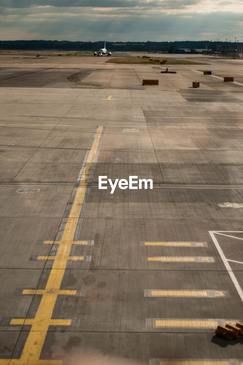 HIGH ANGLE VIEW OF AIRPLANE ON AIRPORT RUNWAY