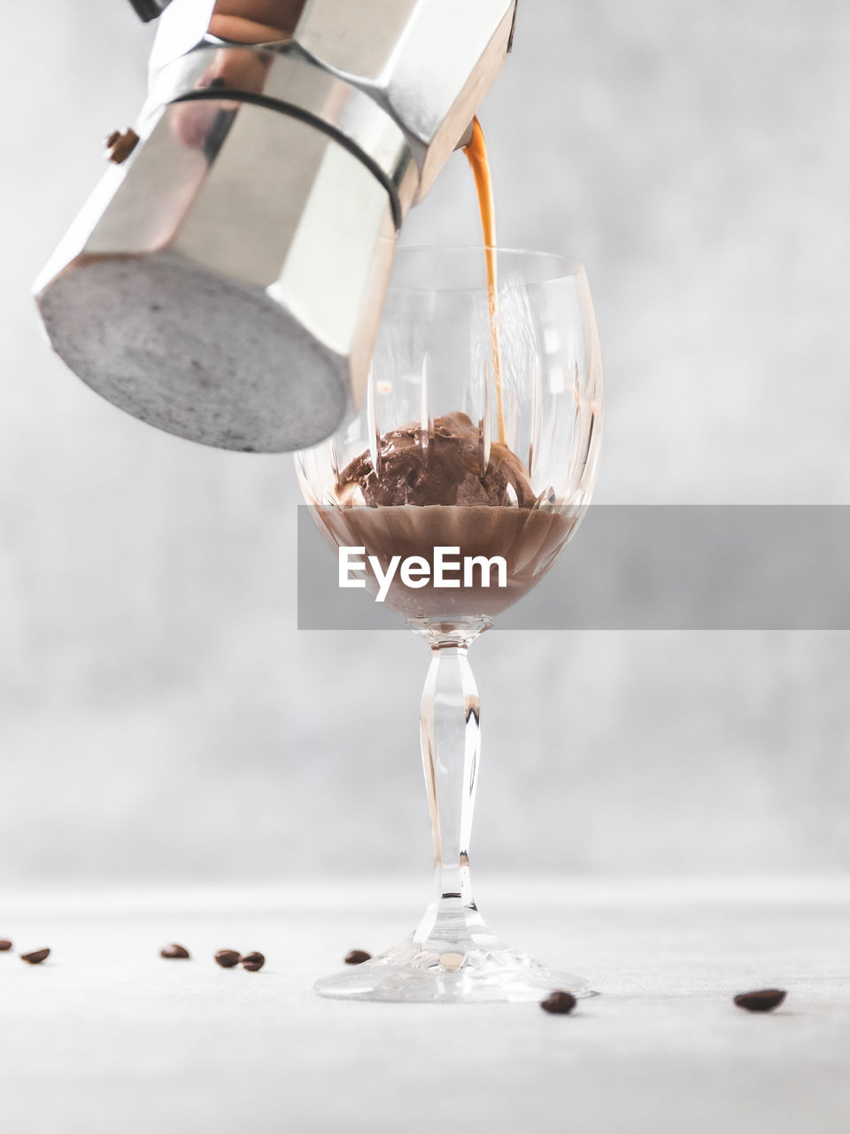 Close-up of wineglass with ice cream and coffee affogato on table