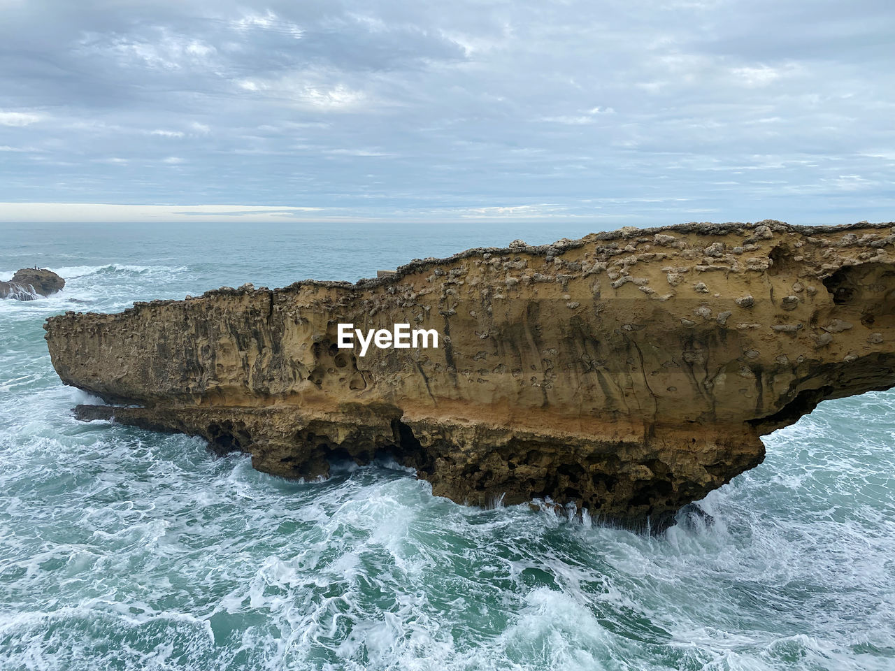 sea, water, ocean, coast, rock, wave, cliff, shore, land, beauty in nature, beach, scenics - nature, nature, wind wave, sky, terrain, rock formation, motion, body of water, bay, cloud, no people, cove, water sports, coastline, outdoors, tranquility, idyllic, horizon over water, non-urban scene, sports, environment, tranquil scene, day, seascape, travel destinations, horizon, rocky coastline, coastal feature, geology, islet