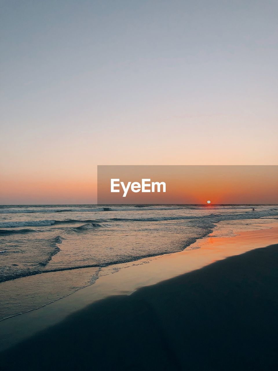 Scenic view of sea against clear sky during sunset