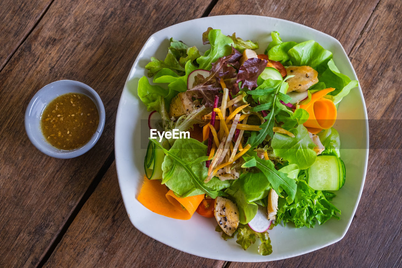 Fresh mixed vegetables salad grilled chicken. top view