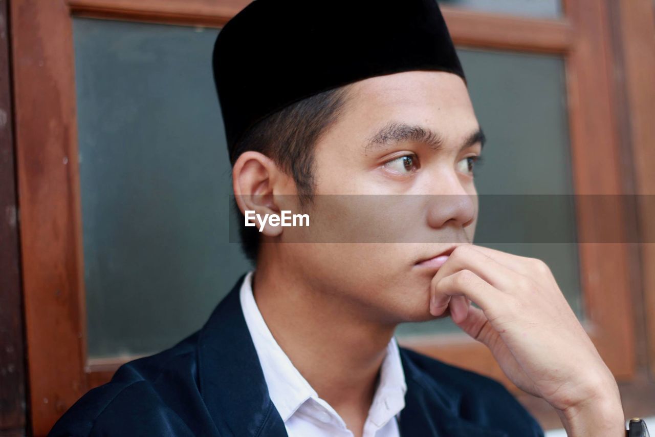 Close-up portrait of asian muslim boy looking away