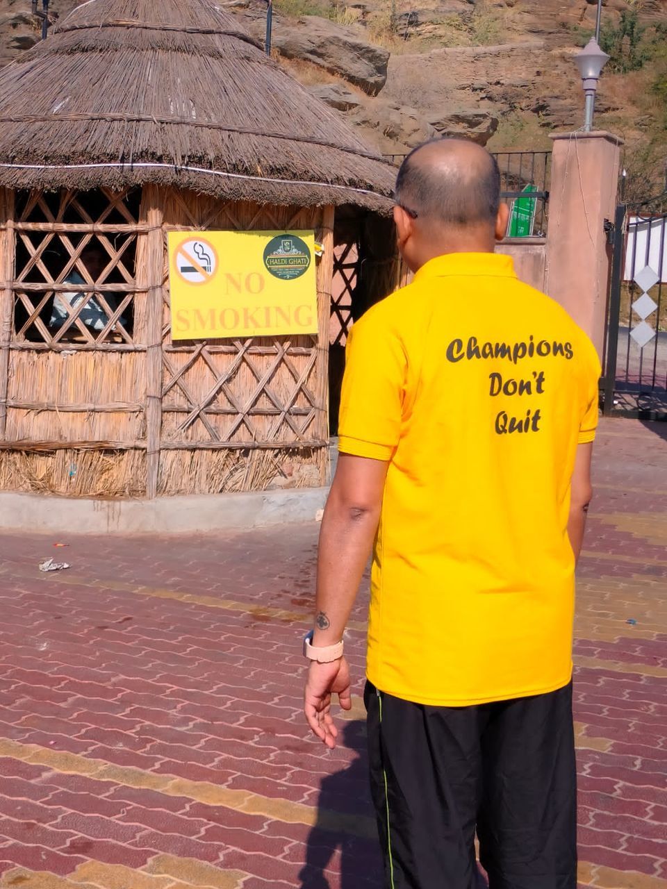 yellow, men, one person, architecture, adult, rear view, standing, day, city, outdoors, lifestyles, person, communication, built structure, clothing, street, three quarter length, nature, casual clothing, text