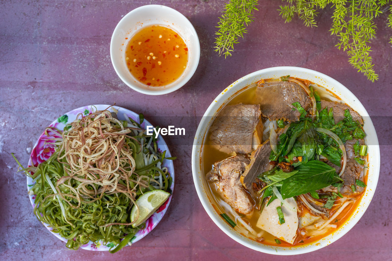 Top view photo of delicious vietnamese spicy beef noodles soup