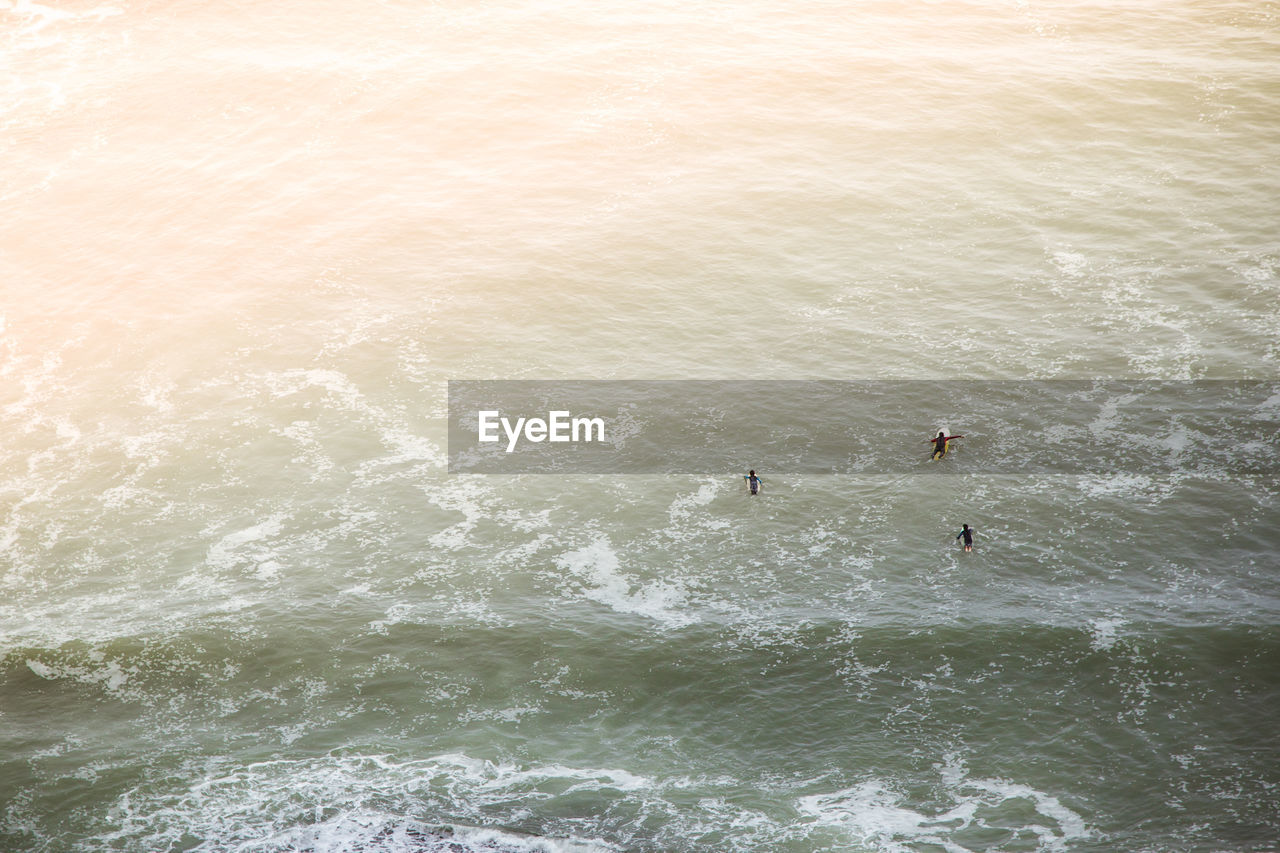 Aerial view of people surfing in sea