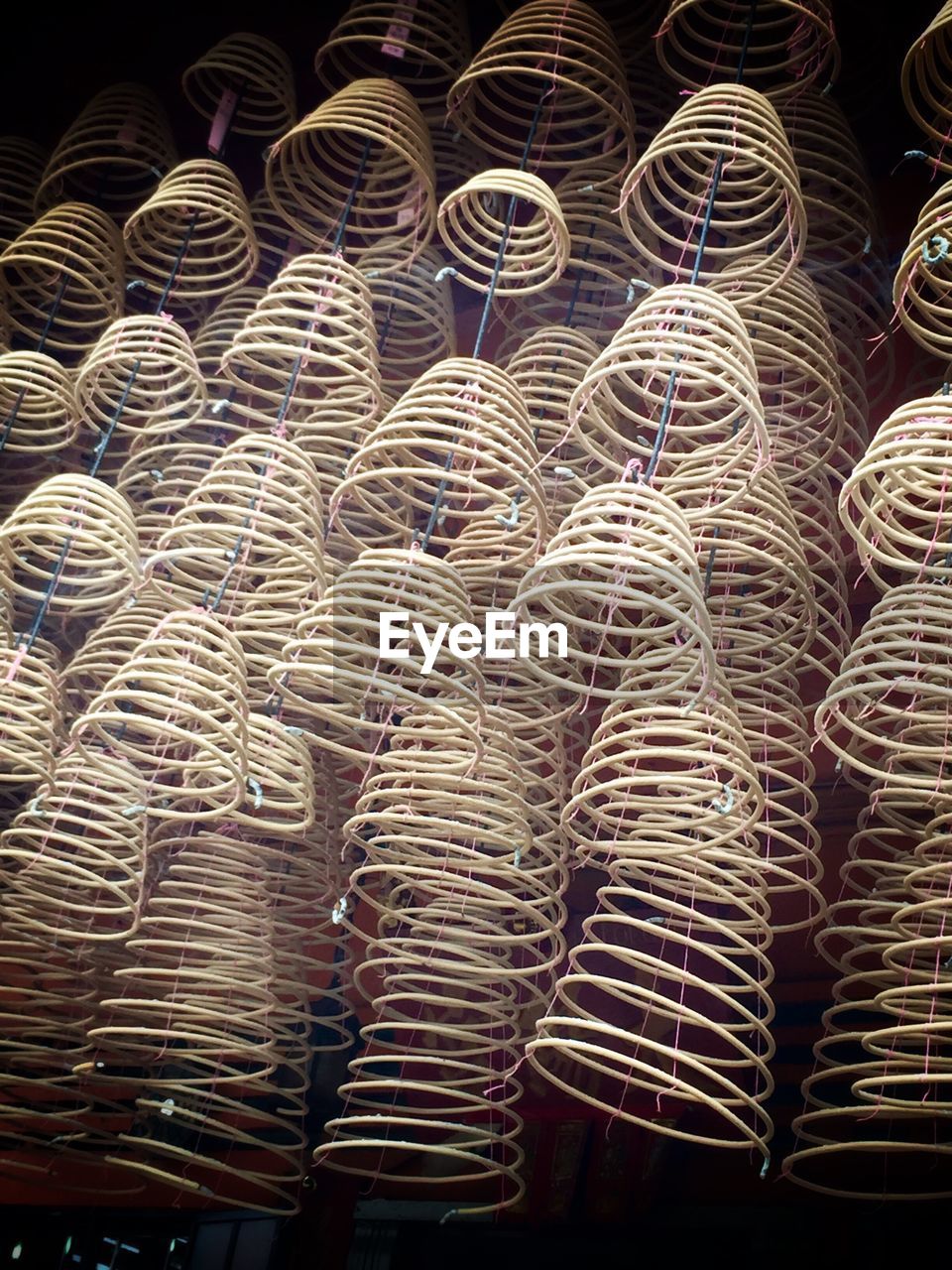 Low angle view of spiral incenses at temple