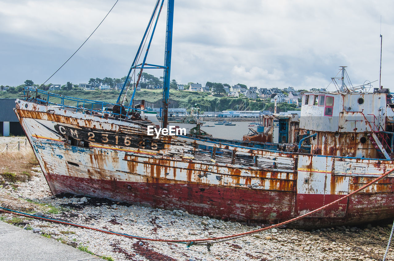 VIEW OF RUSTY SHIP AGAINST SKY