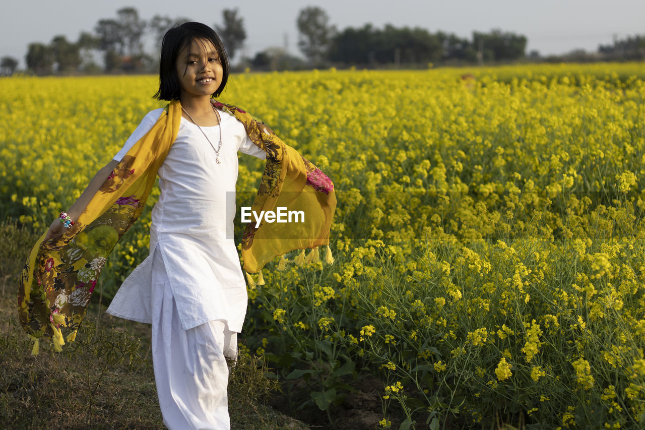 WOMAN STANDING ON FIELD