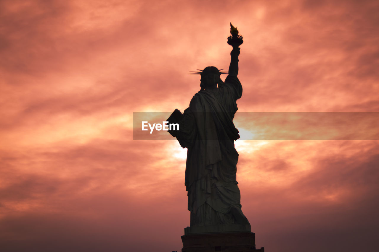 LOW ANGLE VIEW OF STATUE AT SUNSET