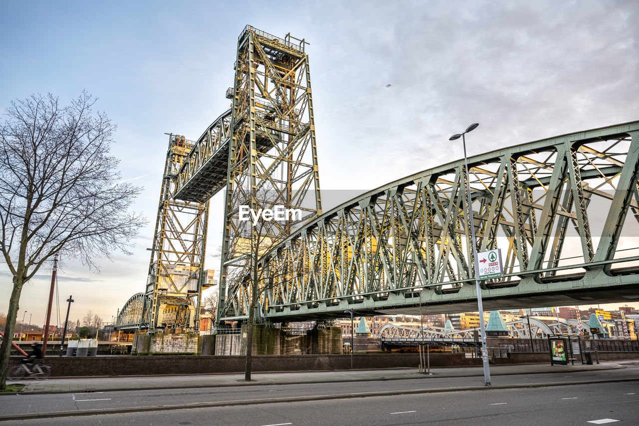 view of bridge over river in city against sky