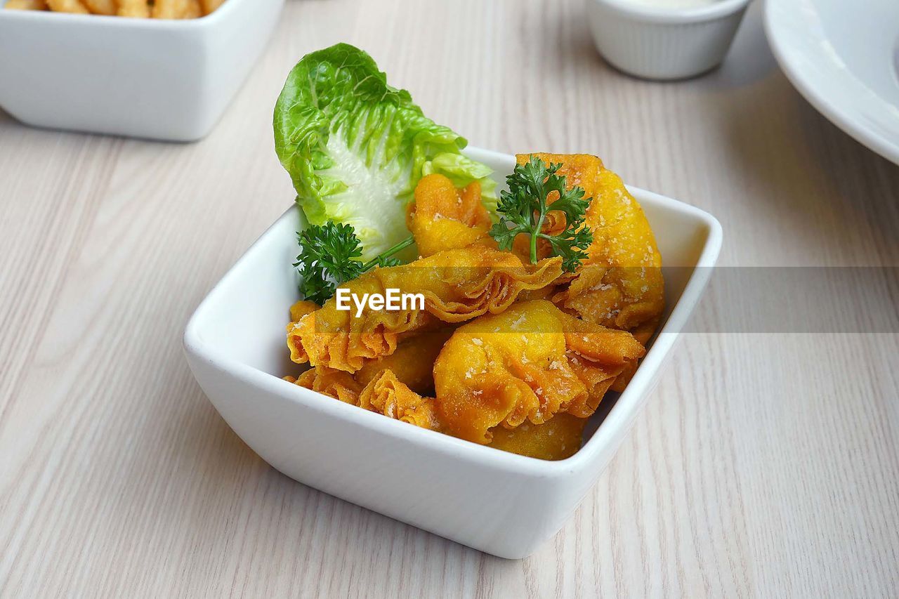 High angle view of fried dumplings in bowl on table