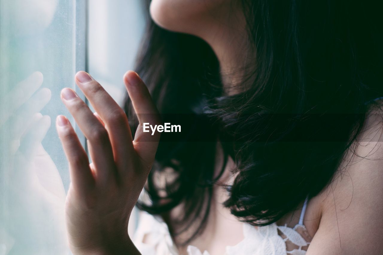 Close-up of woman at window