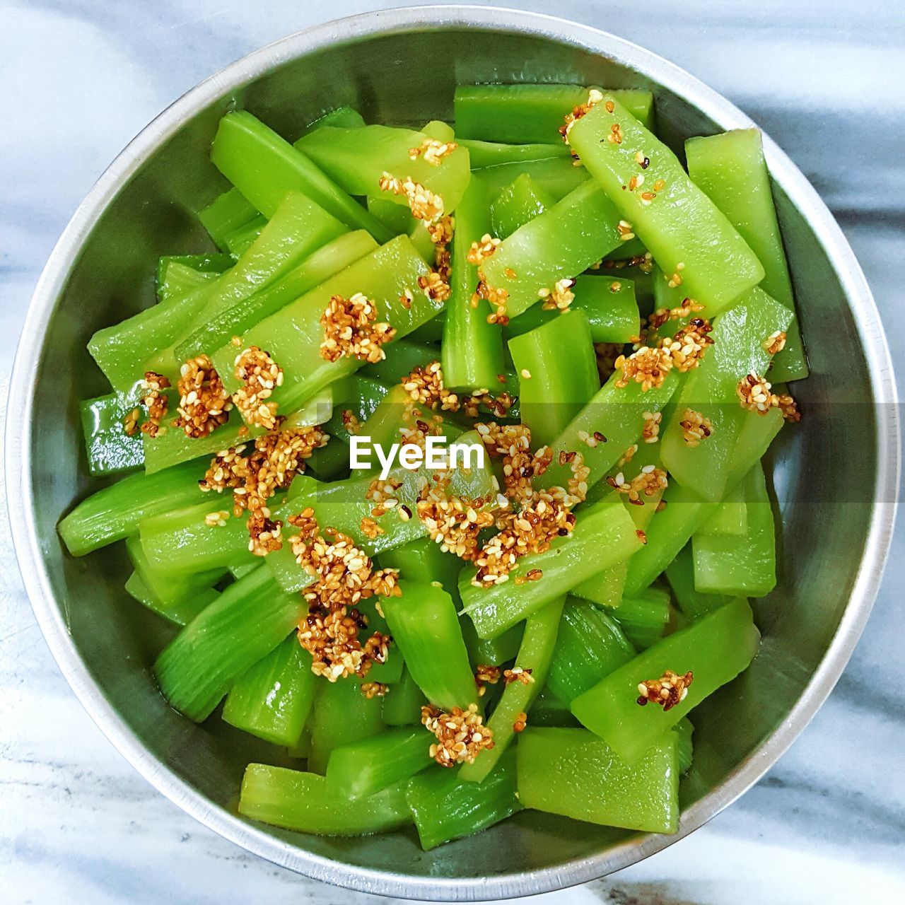 Directly above shot of green vegetable with sesame seed in bowl