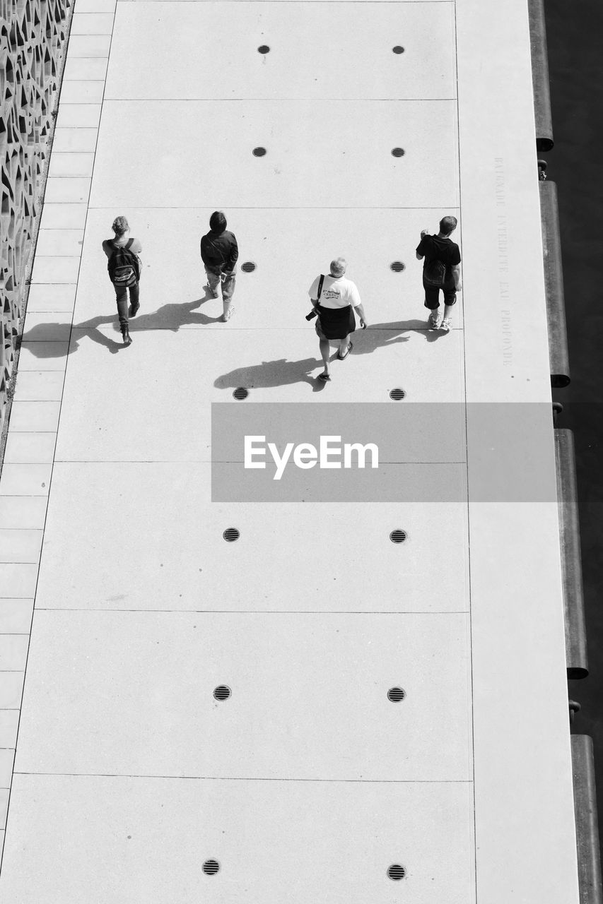 High angle view of people walking on footpath