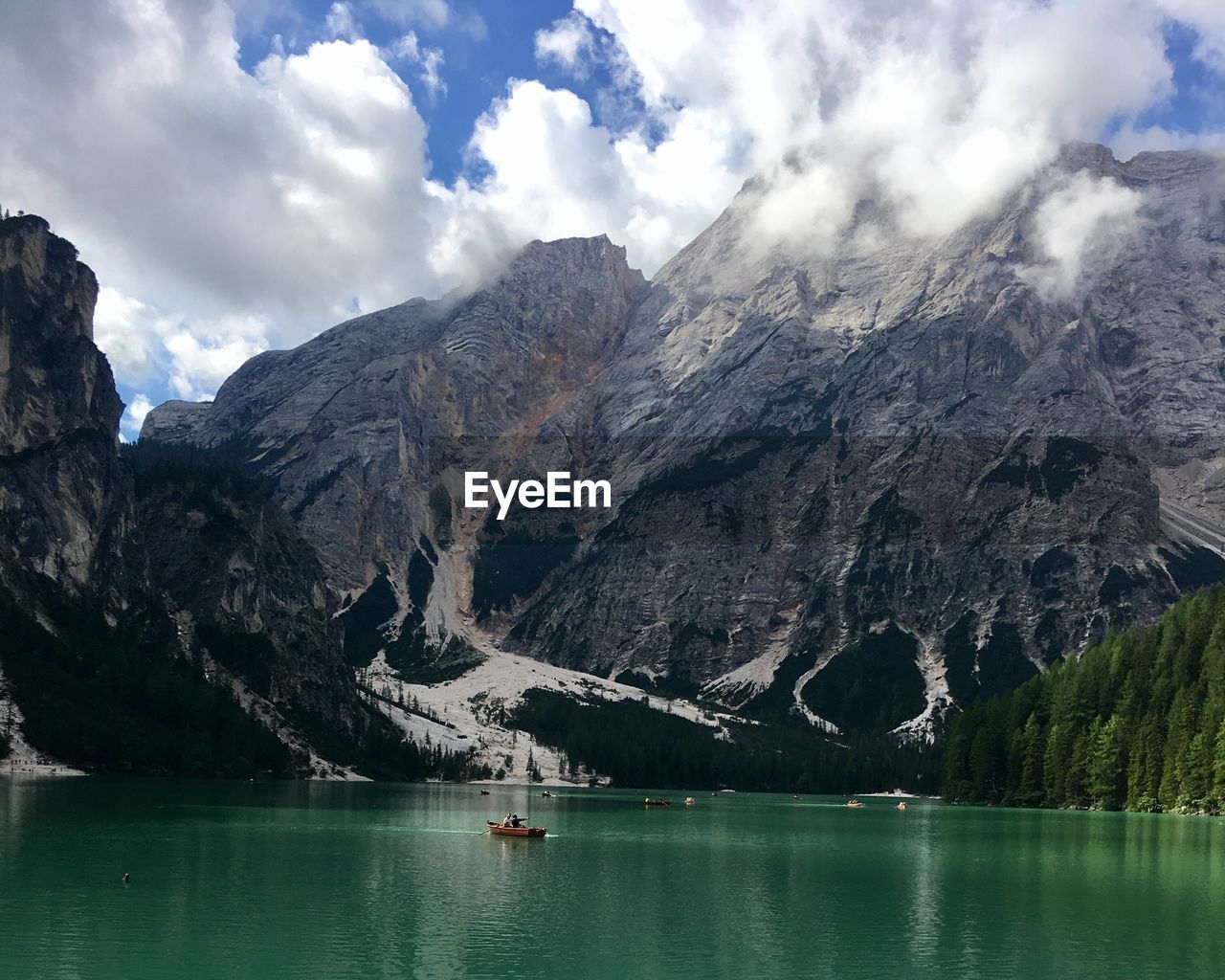 Scenic view of lake by mountains against sky