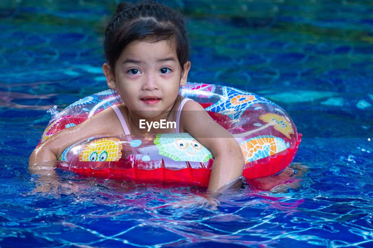 PORTRAIT OF GIRL WITH SWIMMING POOL