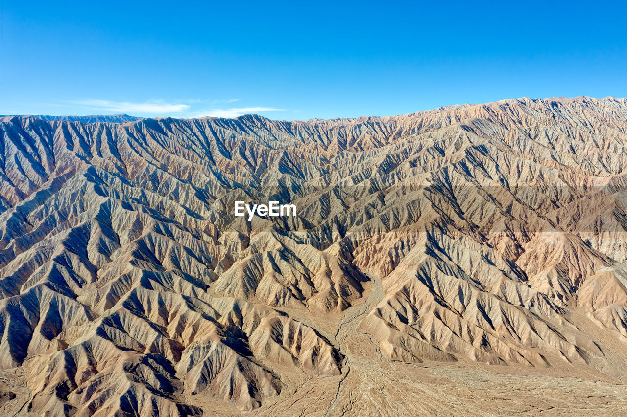 Scenic view of landscape against blue sky