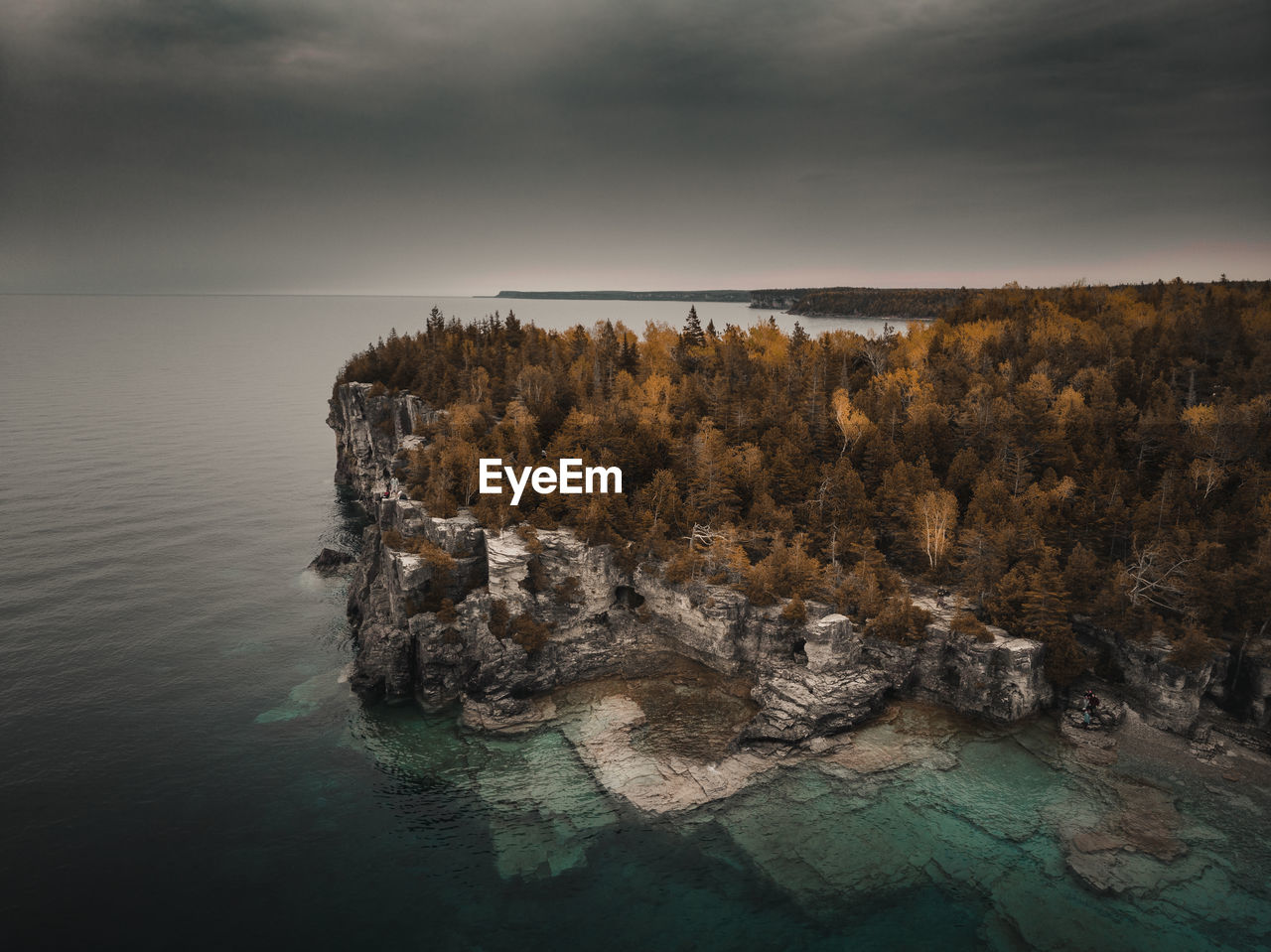 Rock formation in sea against sky