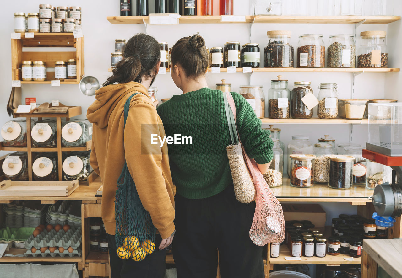 Couple with mesh bags shopping in zero waste store