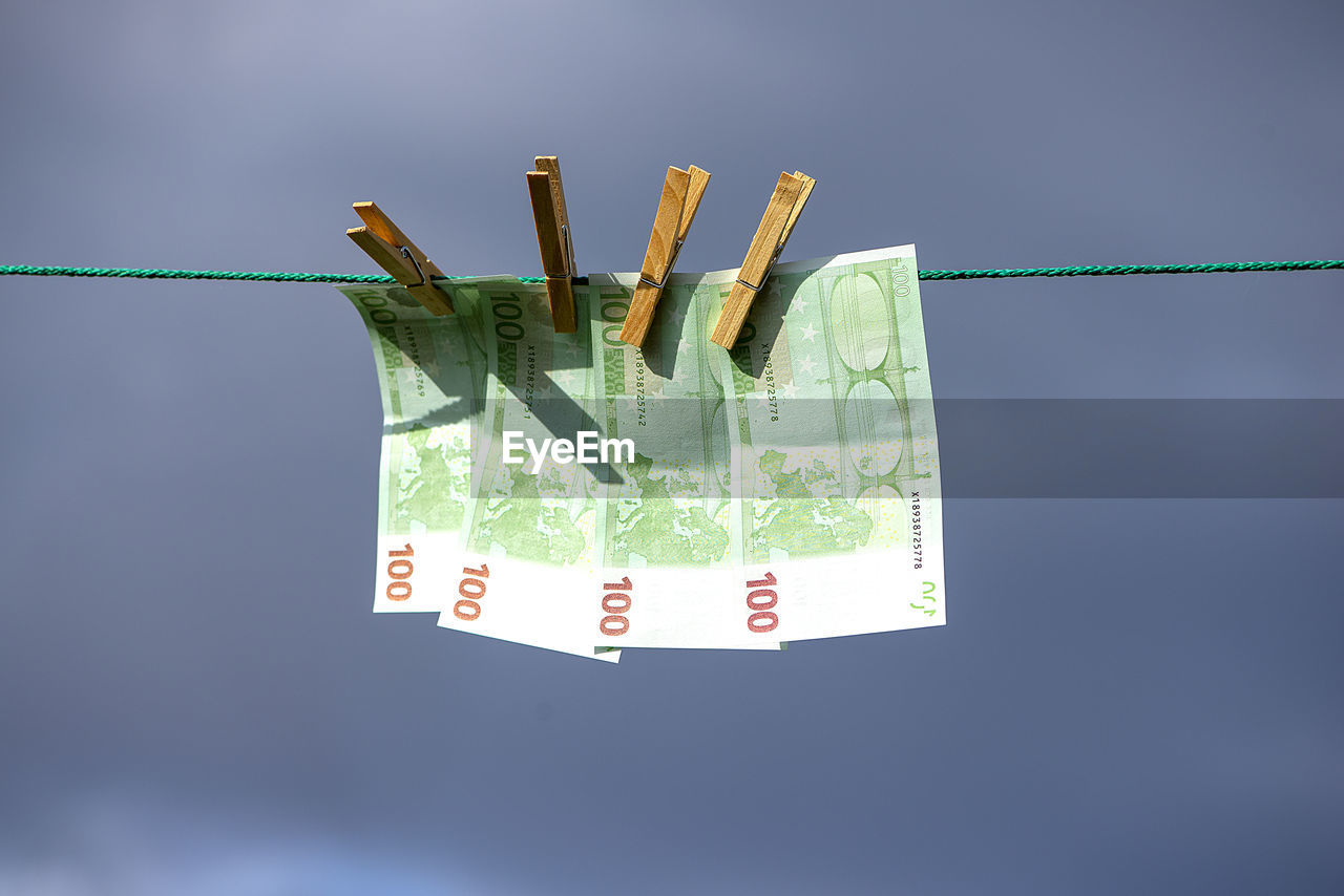 100 euro banknotes on a clothesline. money laundering theme.