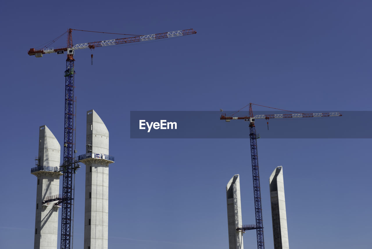 Low angle view of electricity pylon against clear sky