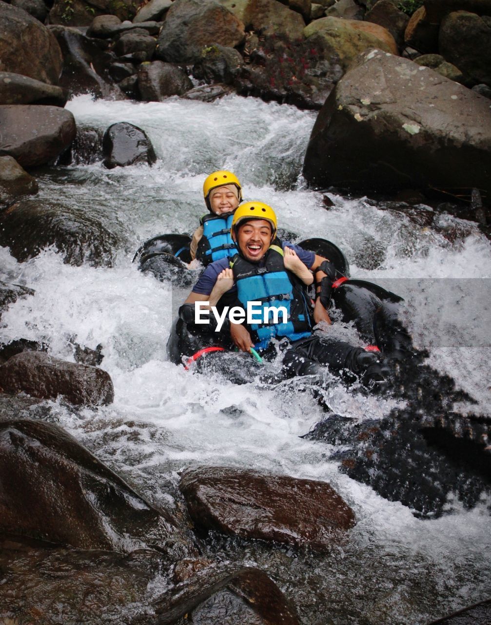 Man and woman surfing in river . river tubbing