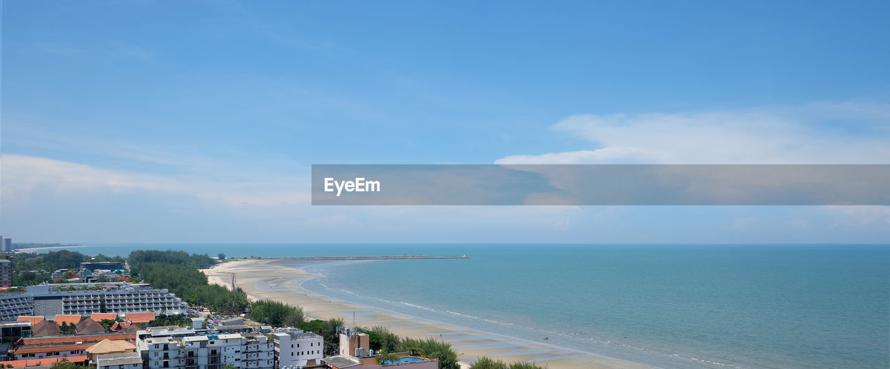 Scenic view of sea against sky in city