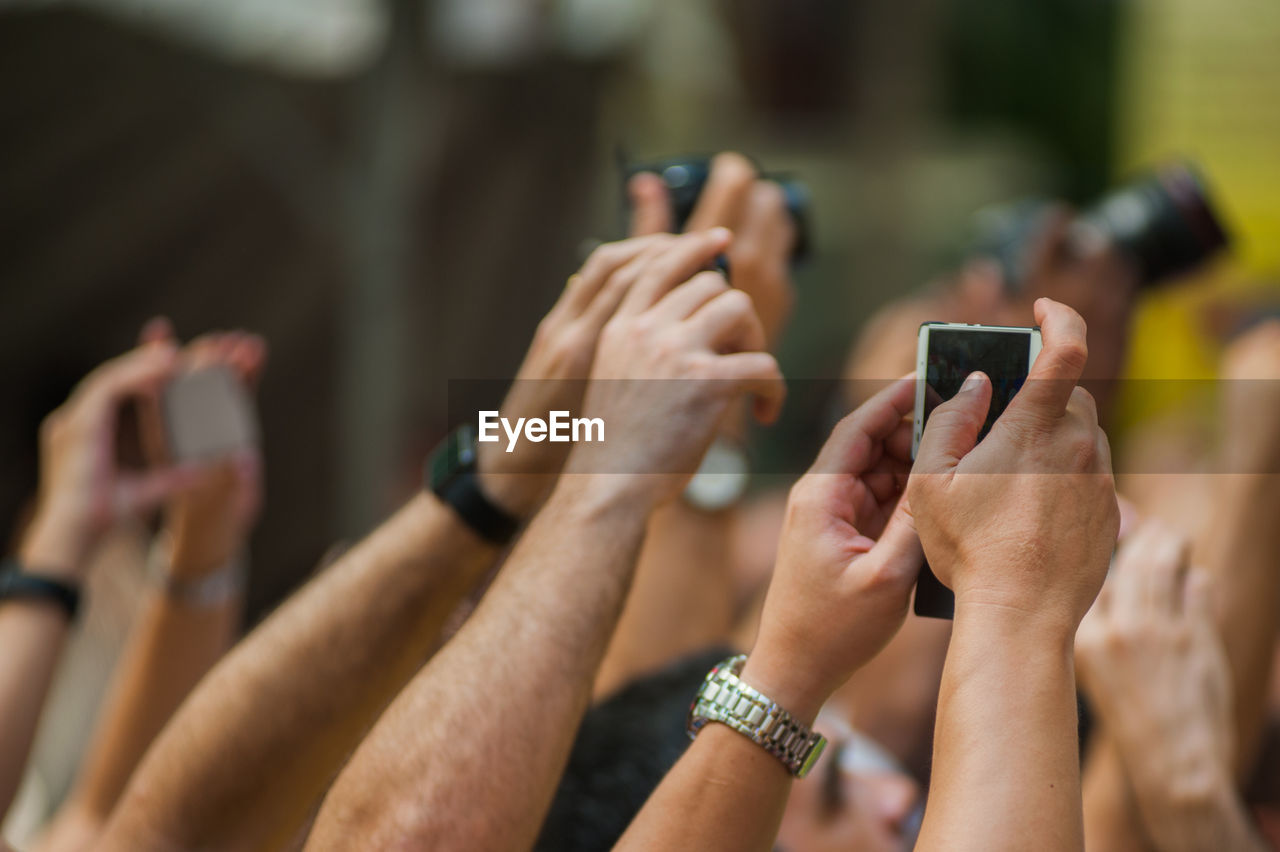 Cropped image of hands photographing