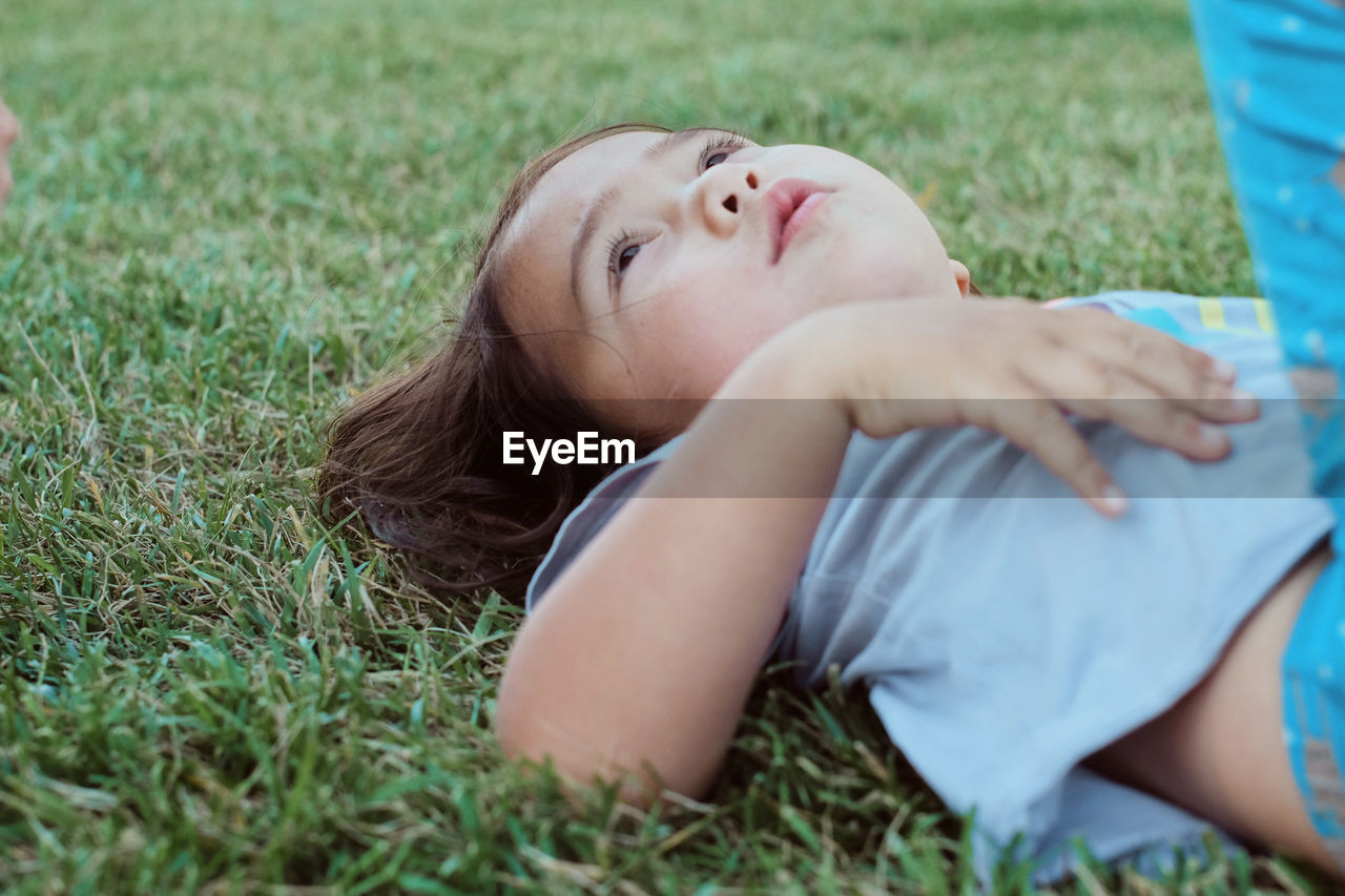 Laying in the grass Boys California Candid Childhood Close-up Cute Day Girls Grass Leisure Activity Lying Down Lying On Back Nature One Person Outdoors People Real People Relaxation USA